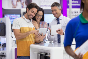 a-salesman-showing-digital-tablets-to-a-young-coup-2025-10-17-00-25-04-utc