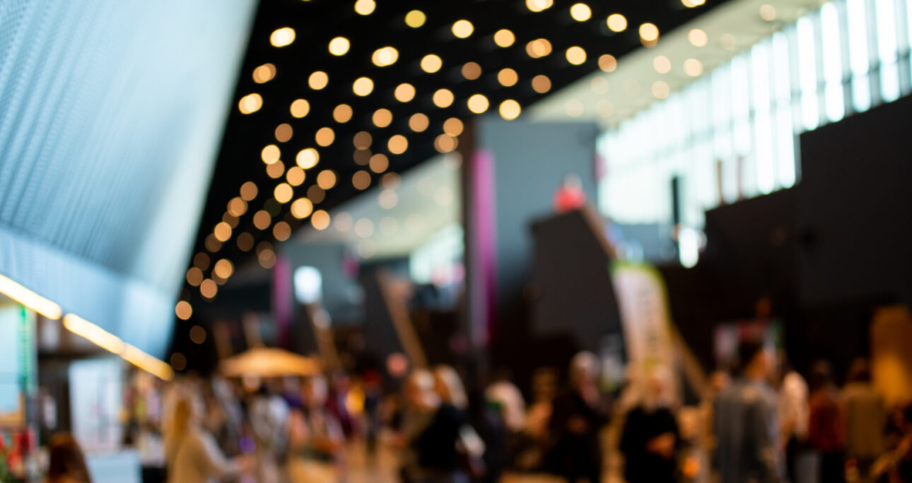 Blurred crowd of people in modern interior during event
