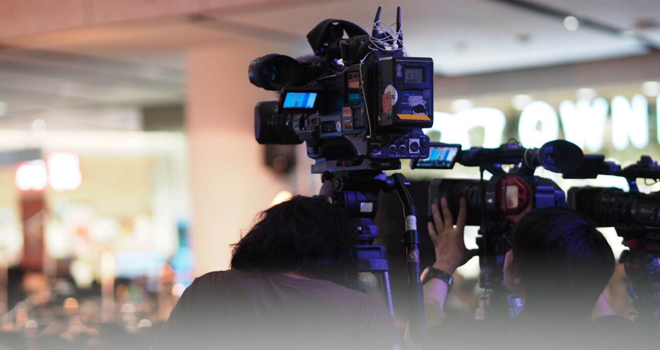 Men standing on camera at the event
