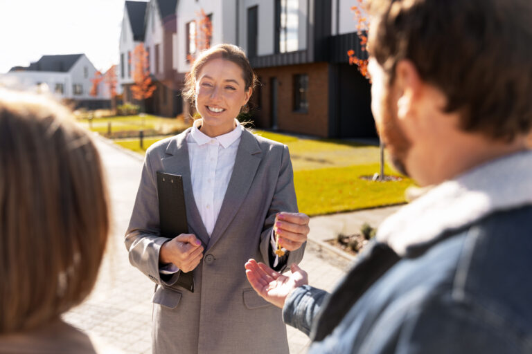 real-estate-agent-handing-keys-to-home-buyer-coupl-2025-12-31-12-00-52-utc