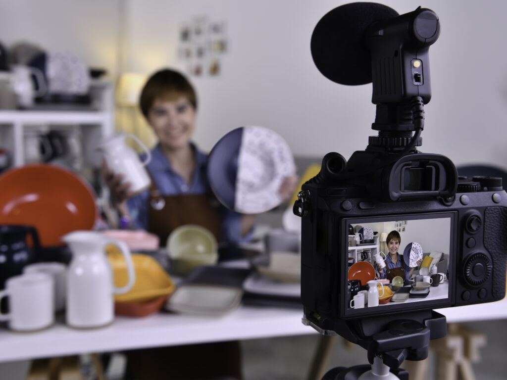 Asian woman blogger vlogger and online influencer recording video content on online marketing and selling and e-commerce for ceramic making and products